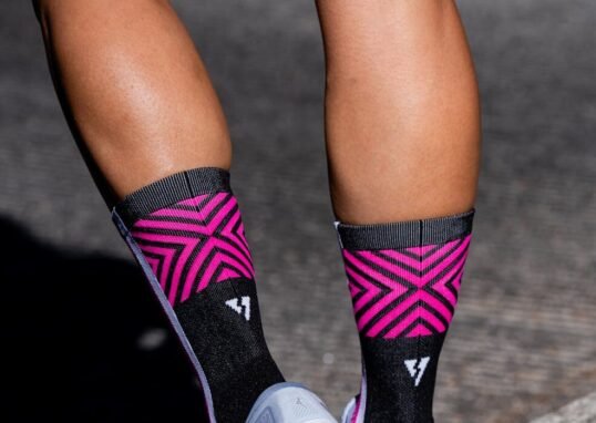 Vibrant running socks and sneakers on a jogging trail, depicting fitness and style.