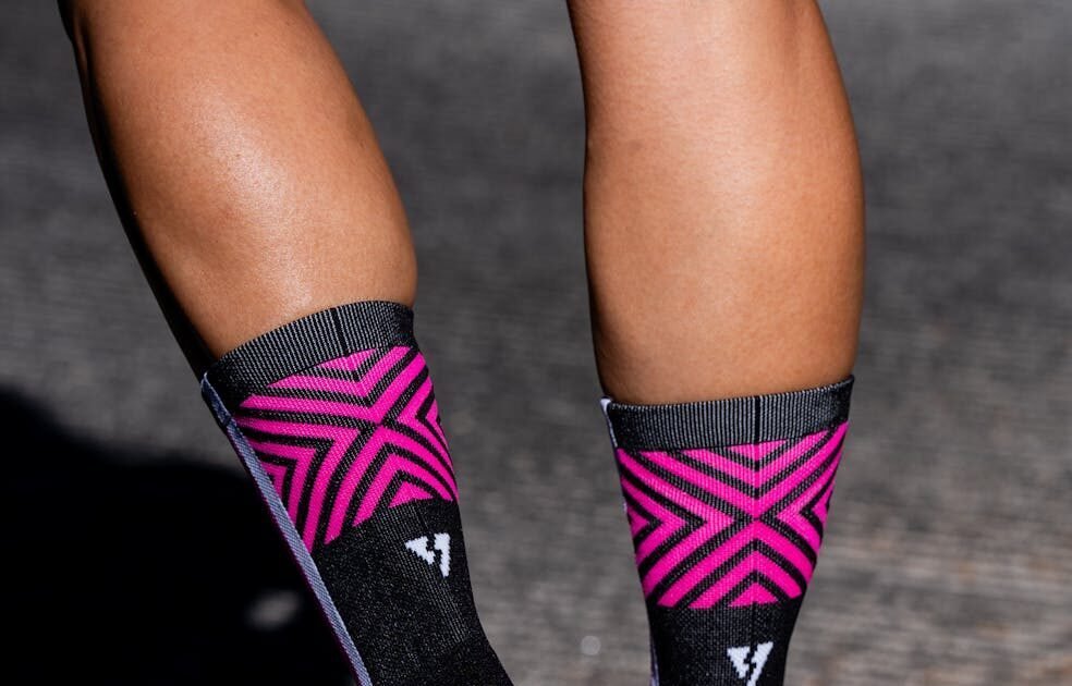Vibrant running socks and sneakers on a jogging trail, depicting fitness and style.