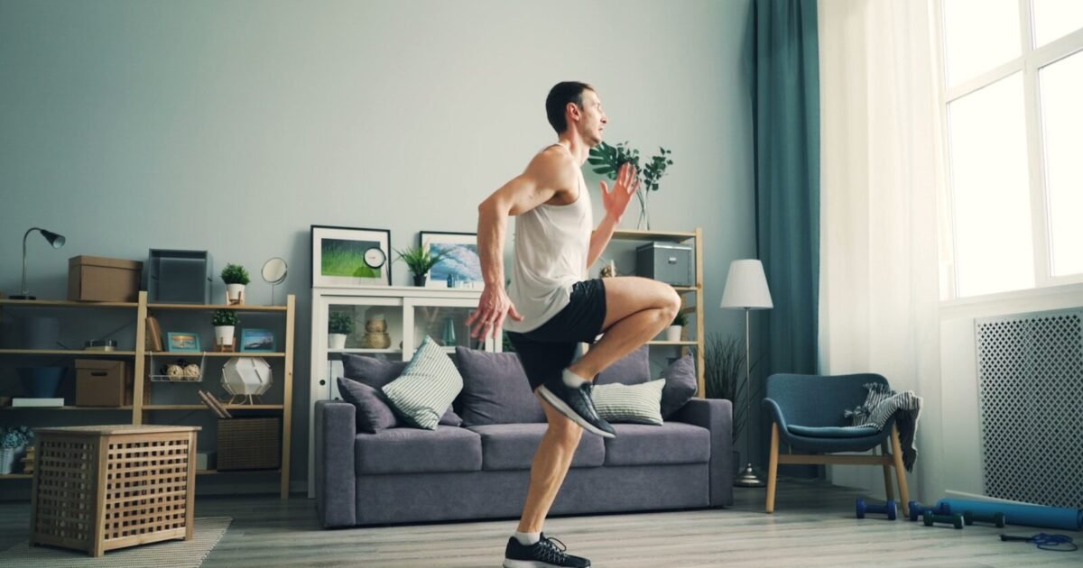 a man is dancing in a living room