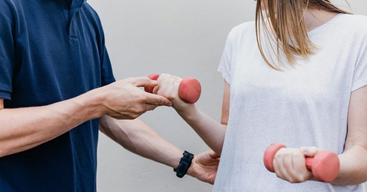 a man and a woman holding dumbs in their hands