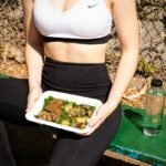woman wearing white and black Nike sports bra