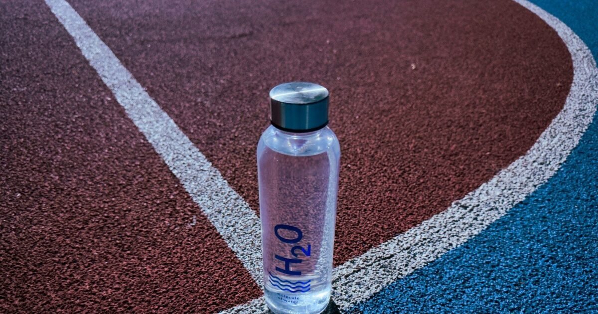 a bottle of water sitting on a tennis court