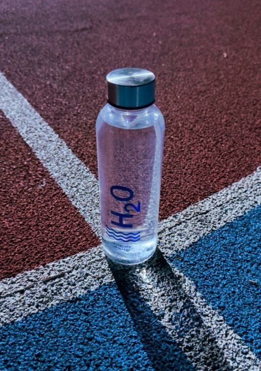 a bottle of water sitting on a tennis court