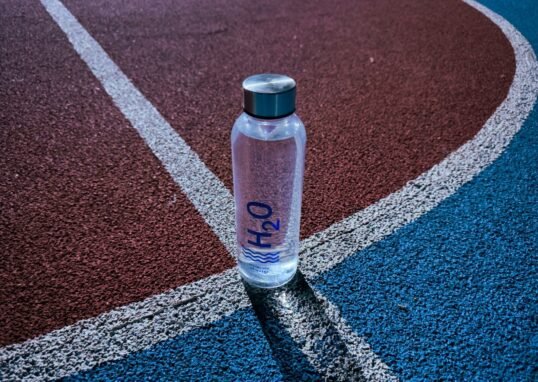 a bottle of water sitting on a tennis court