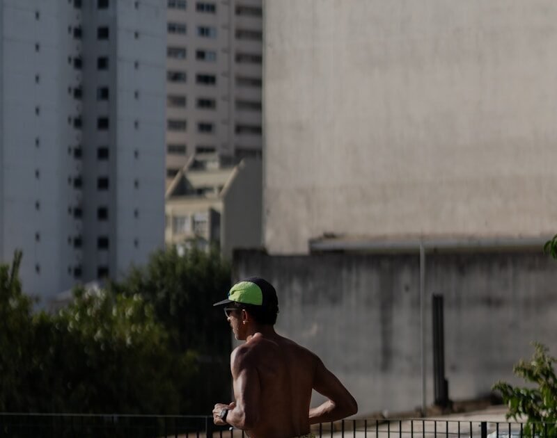 A shirtless man running on a city street