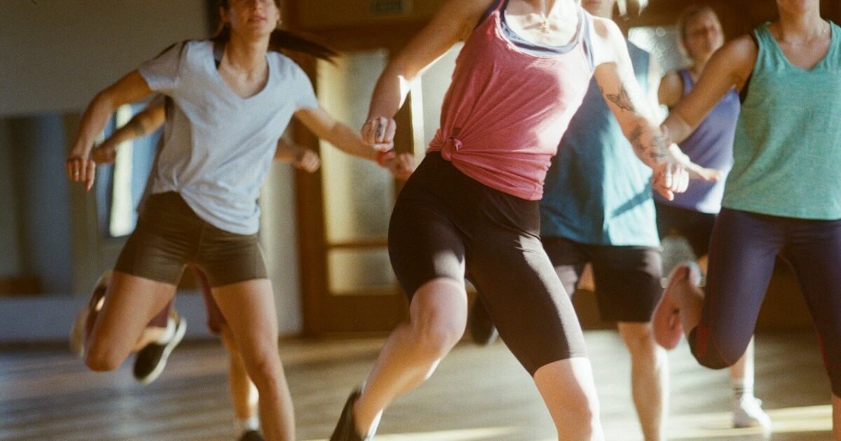 group of women running on brown wooden floor