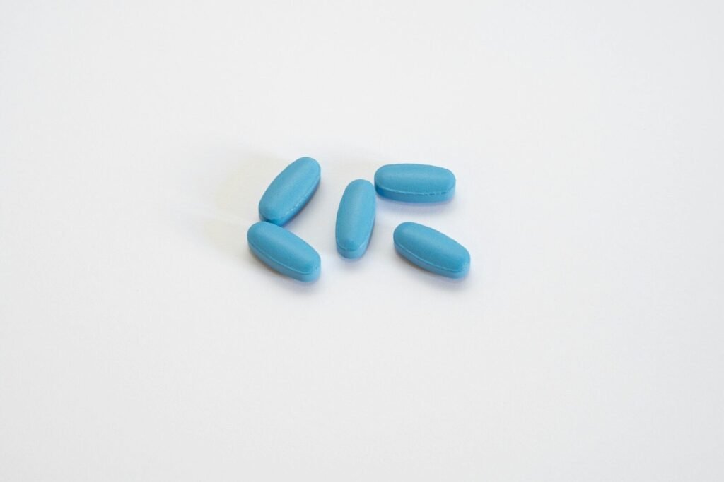 a group of blue pills sitting on top a white table