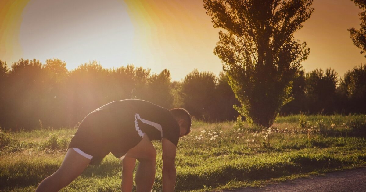 a person bending over on a road