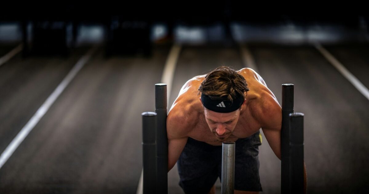 A man is doing push ups on a bench