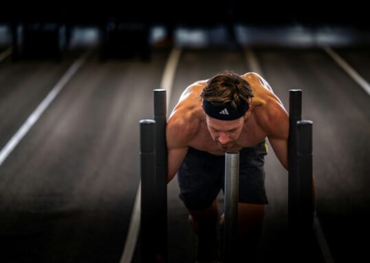 A man is doing push ups on a bench
