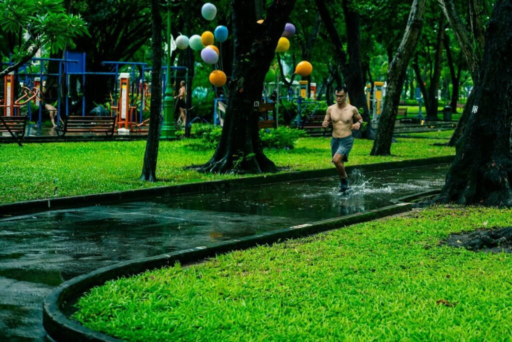 Man running on wet path in a park