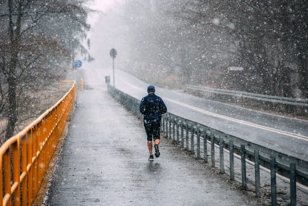 A man walking down a road in the snow
