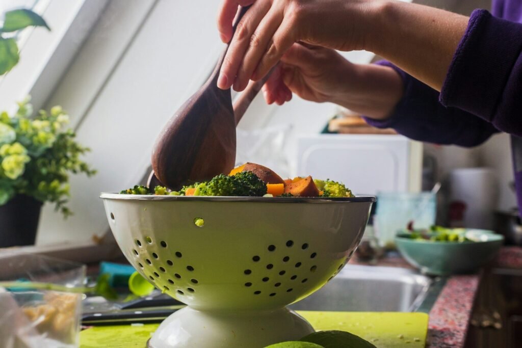 person holding brown wooden ladle