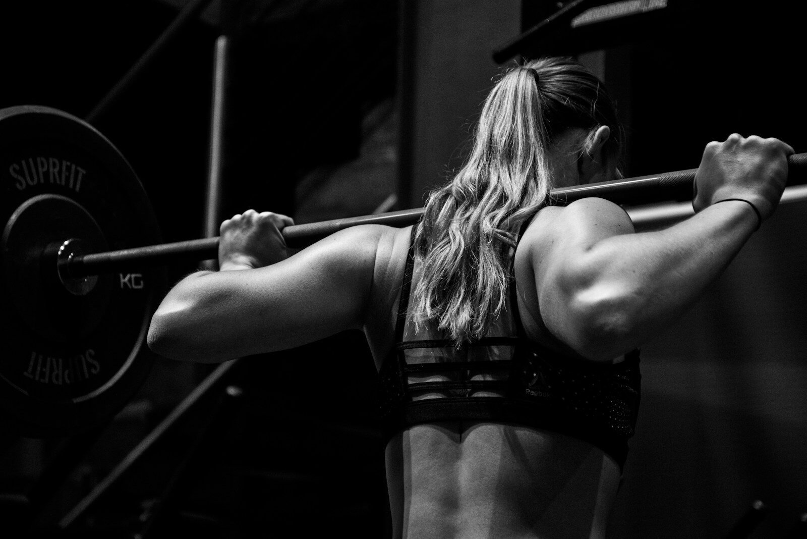 Mulher praticando musculação para aumentar a massa magra e otimizar a saúde metabólica.
